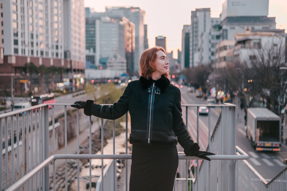Solo traveler enjoying sunset views in Seoul city streets