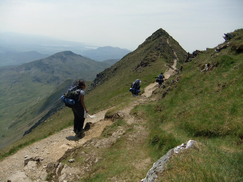 Hikers trekking the Snowdon Summit Trail, one of the best hiking trails in the UK 