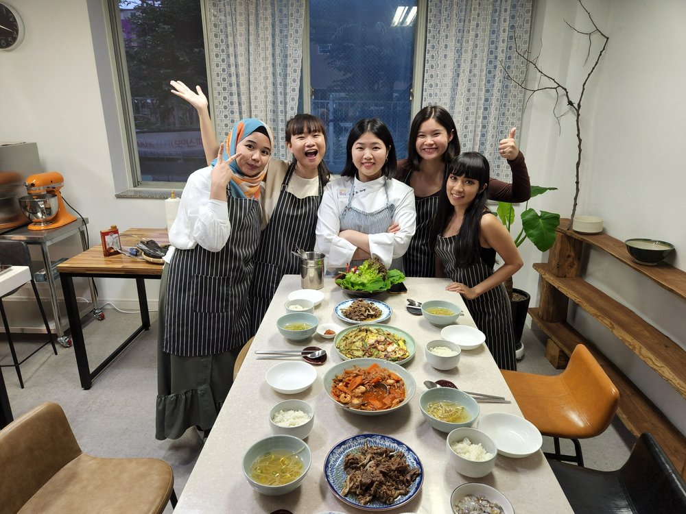 Group cooking Korean food together in Busan cooking class