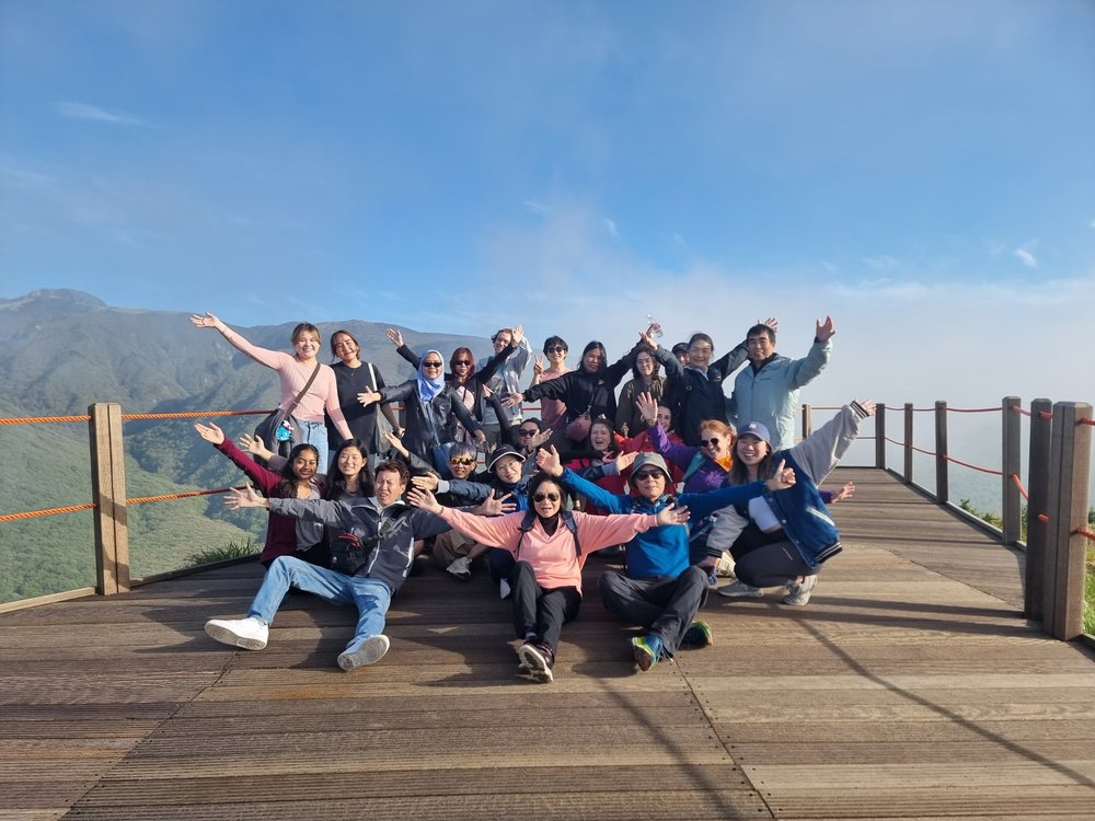 Travelers posing at Mount Hallasan viewpoint in Jeju Island Korea