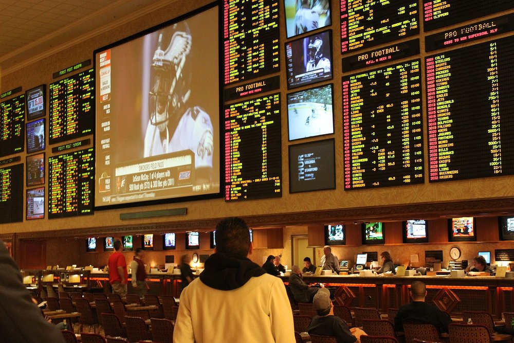 Sportsbook in Las Vegas with large screens and betting boards during March Madness