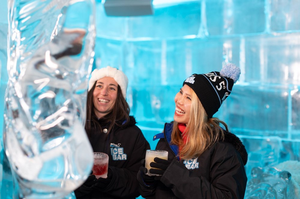 Guests wearing parkas drink cocktails inside the Minus5 Ice Experience ice bar in Las Vegas