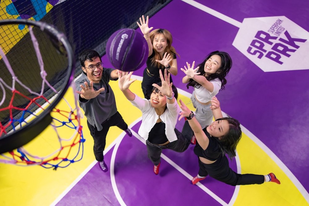 5 teens playing basketball at SuperPark Singapore