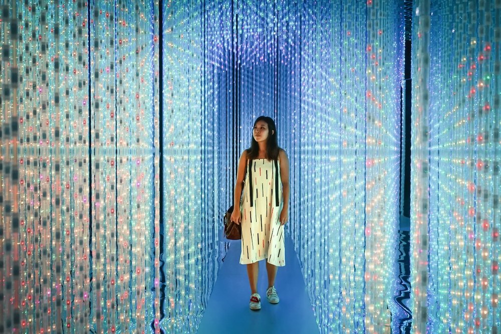 Mother and daughters at sparkling exhibit at ArtScience Museum in Singapore