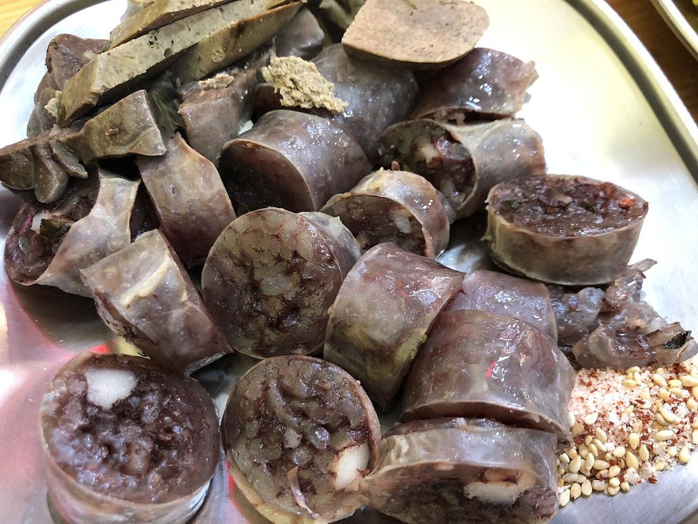 Korean soondae blood sausage slices with dipping salt at a Seoul street food market