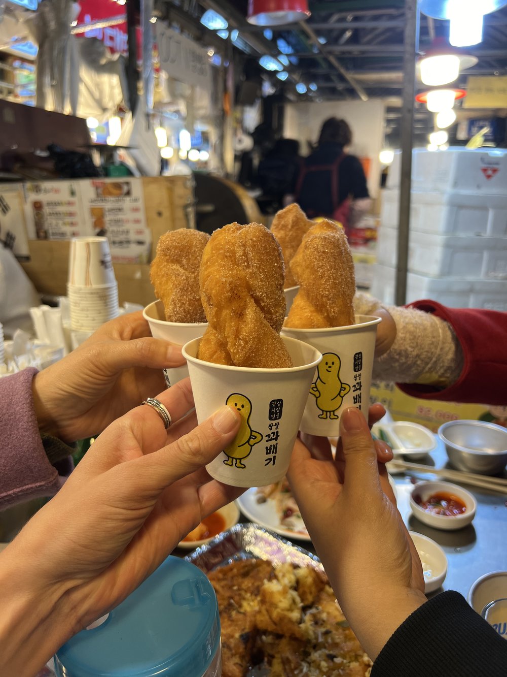 Korean kkwabaegi twisted sugar doughnuts served at a Seoul street food stall