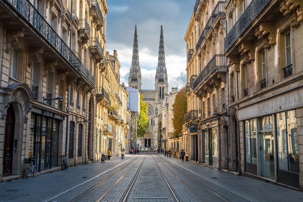 Historic street view of Bordeaux city with cathedral, one of the nicest cities in France