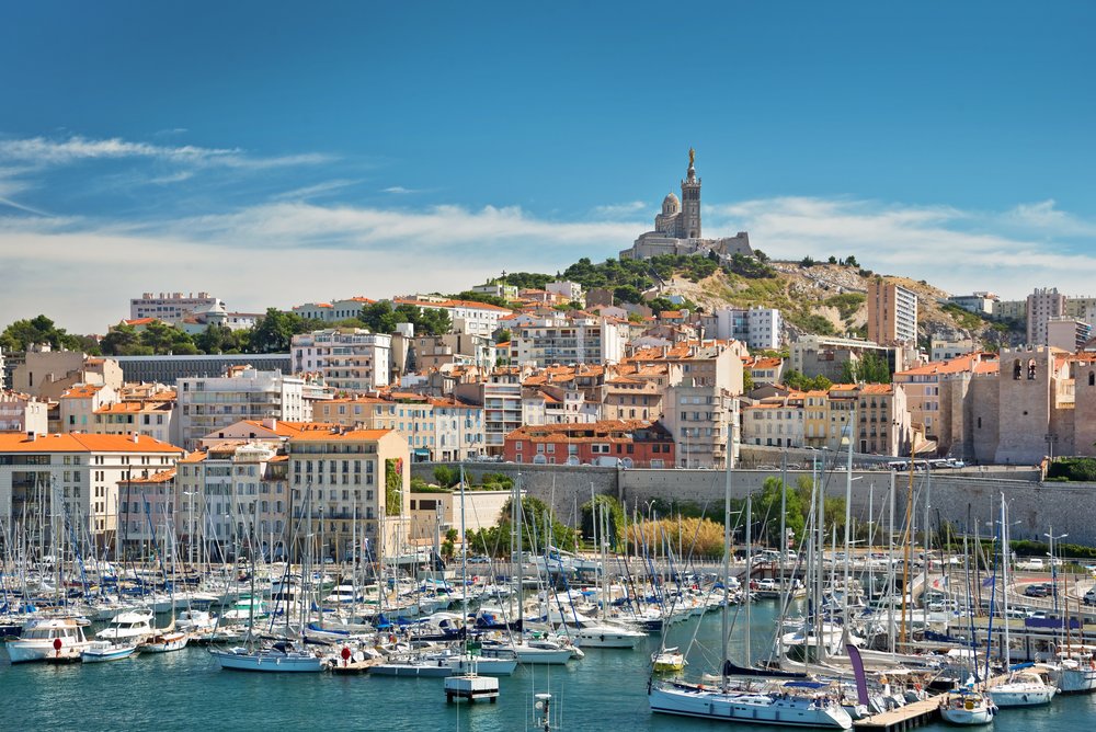 Old Port of Marseille with boats and Notre-Dame de la Garde overlooking the city