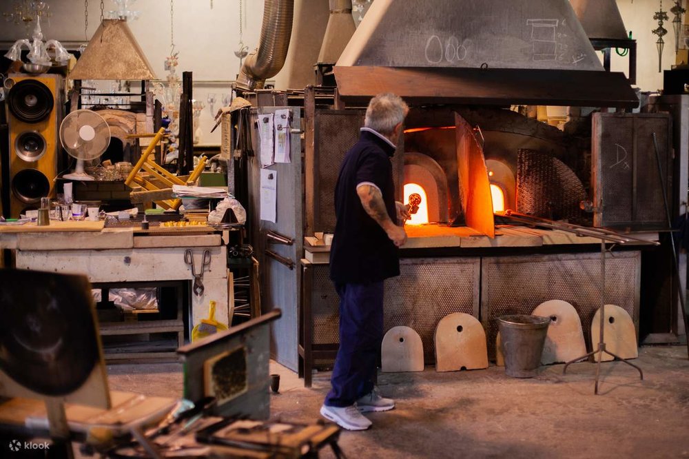 A man putting glass in a fire