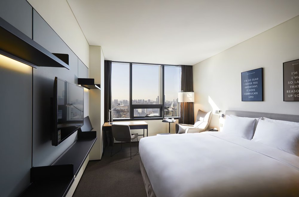Contemporary guest room with city skyline view at GLAD Mapo in Seoul
