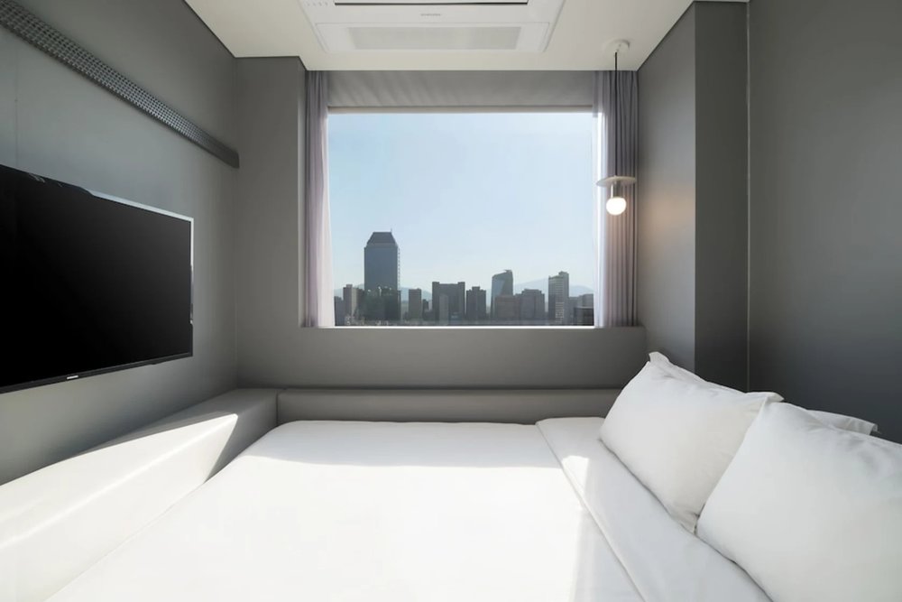 Modern minimalist hotel room with twin beds at Hotel Cappuccino in Gangnam