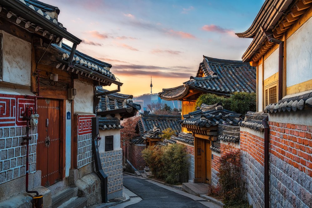 Traditional hanok houses in Bukchon Hanok Village with Seoul skyline view