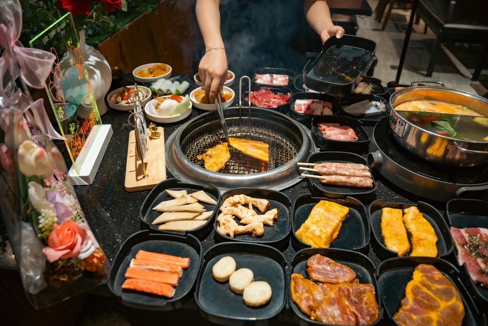 Korean BBQ grill experience with meats and side dishes