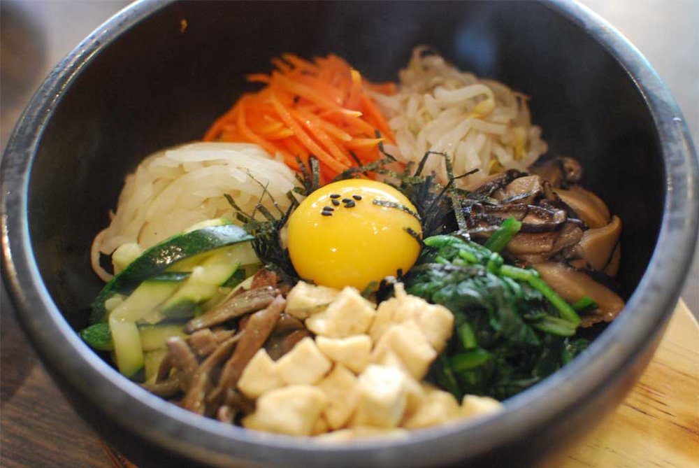 Traditional bibimbap bowl with vegetables and egg