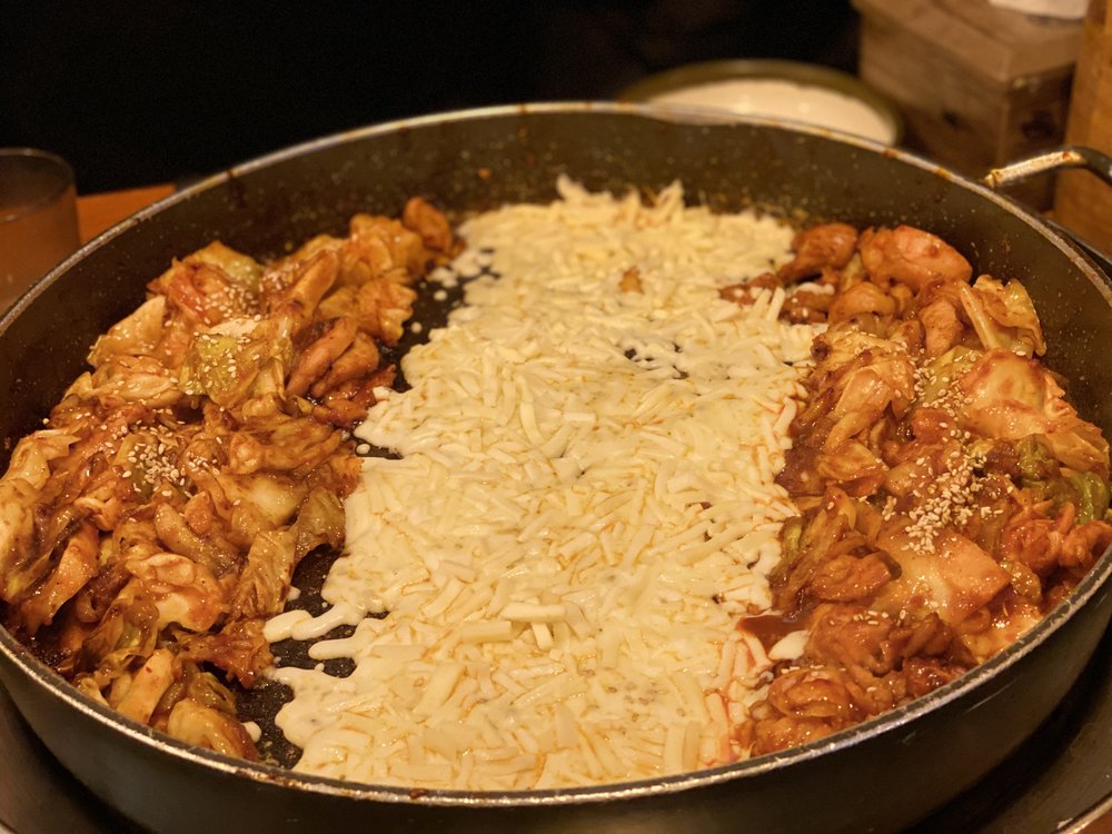 Spicy dakgalbi with melted cheese on hot pan
