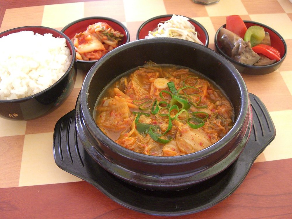 Hot and spicy kimchi jjigae with rice and sides
