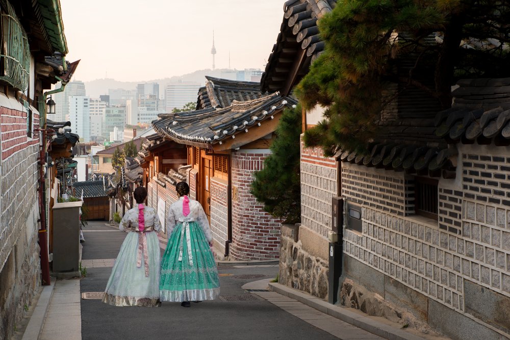 Visitors in hanbok walking through Bukchon Hanok Village in Seoul