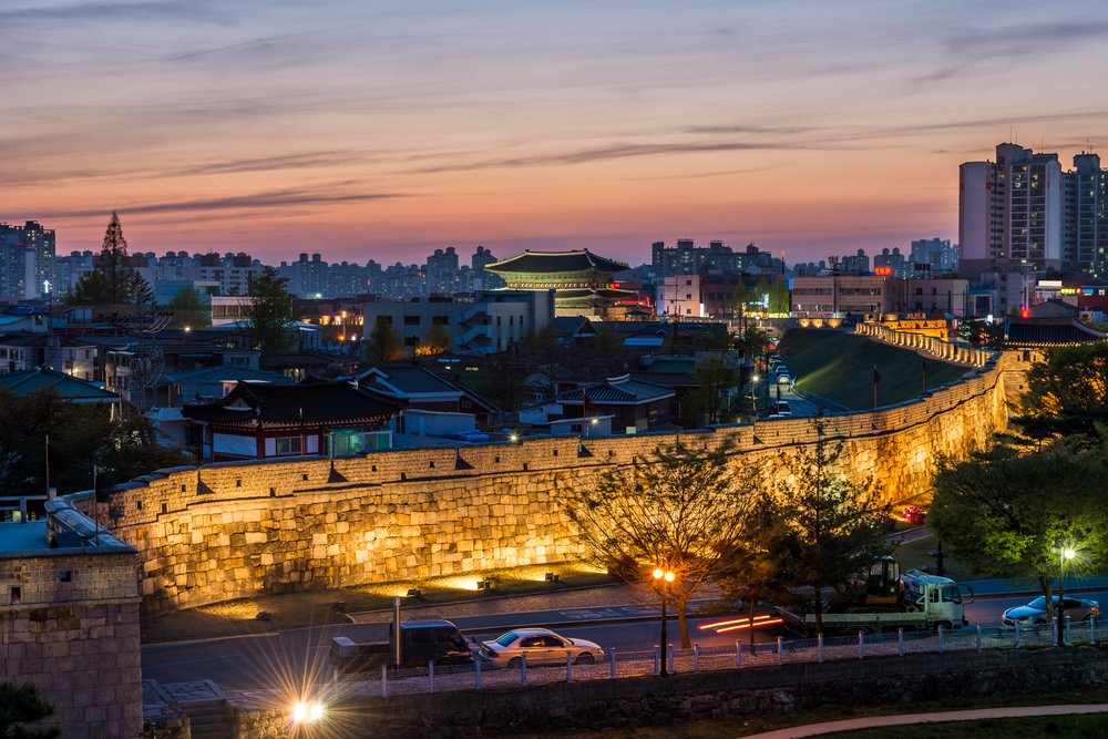 Historic Hwaseong Fortress walls glowing at night in Suwon