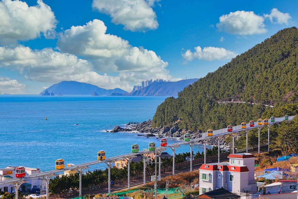 Colorful sky capsule train riding along Busan’s Haeundae coastline