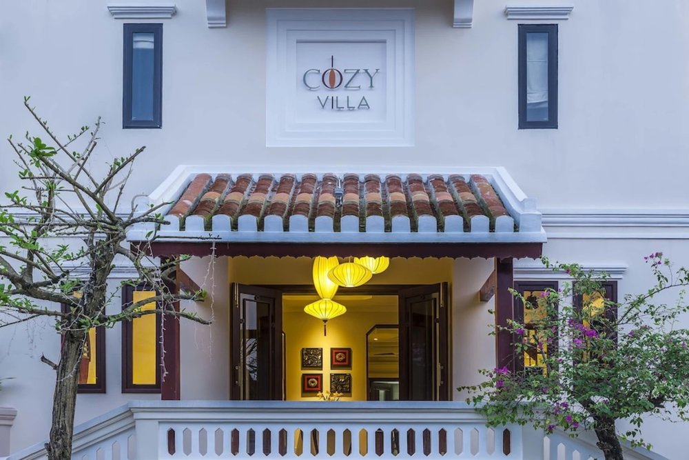 The welcoming entrance of Cozy Hoian Boutique Villas with traditional lanterns