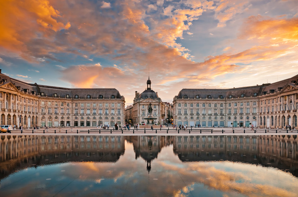 Place de la Bourse Bordeaux reflecting city architecture at sunset