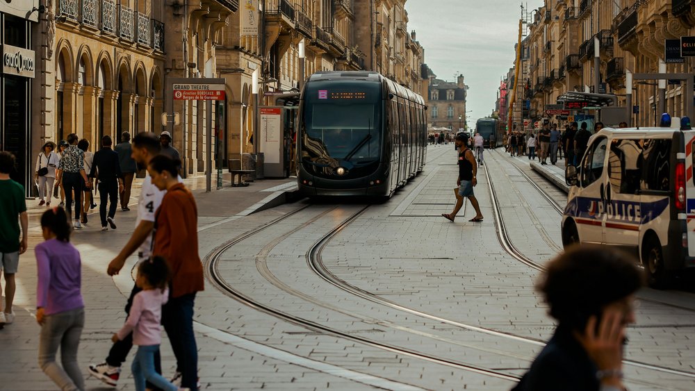 Bordeaux tram on historic street with pedestrians and classic architecture | Photo from TBD Traveller on Pexels