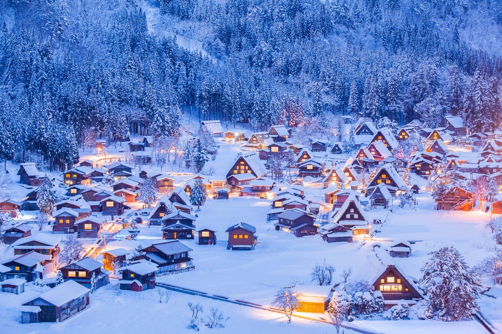 Shirakawago winter view with snow-covered gassho-style houses and forest