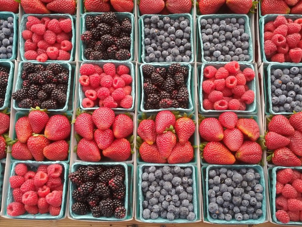 Baskets of strawberries, blueberries, and raspberries at LA market