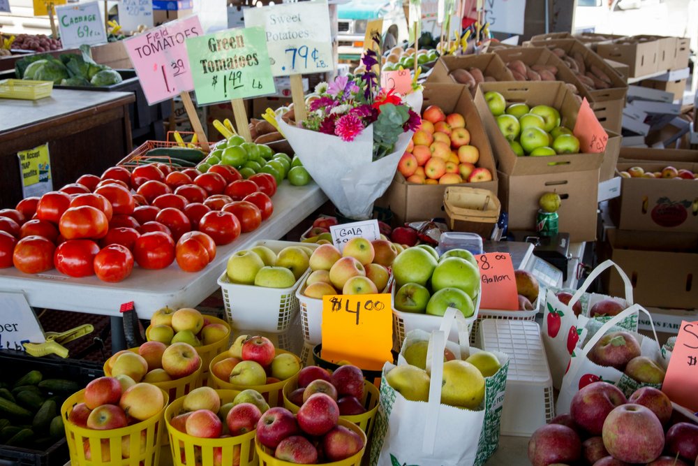Apples and fruits arranged at a Los Angeles farmers market stall
