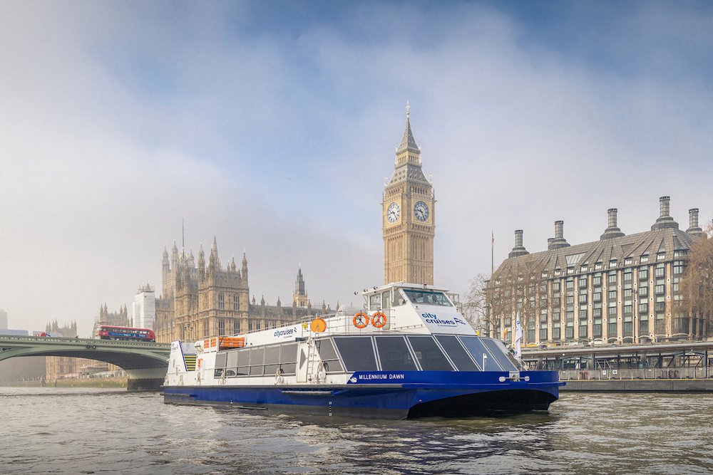 Tour boat on the River Thames with Big Ben and the Houses of Parliament in London