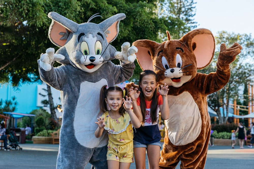 Two kids posing with Tom & Jerry at Movie World