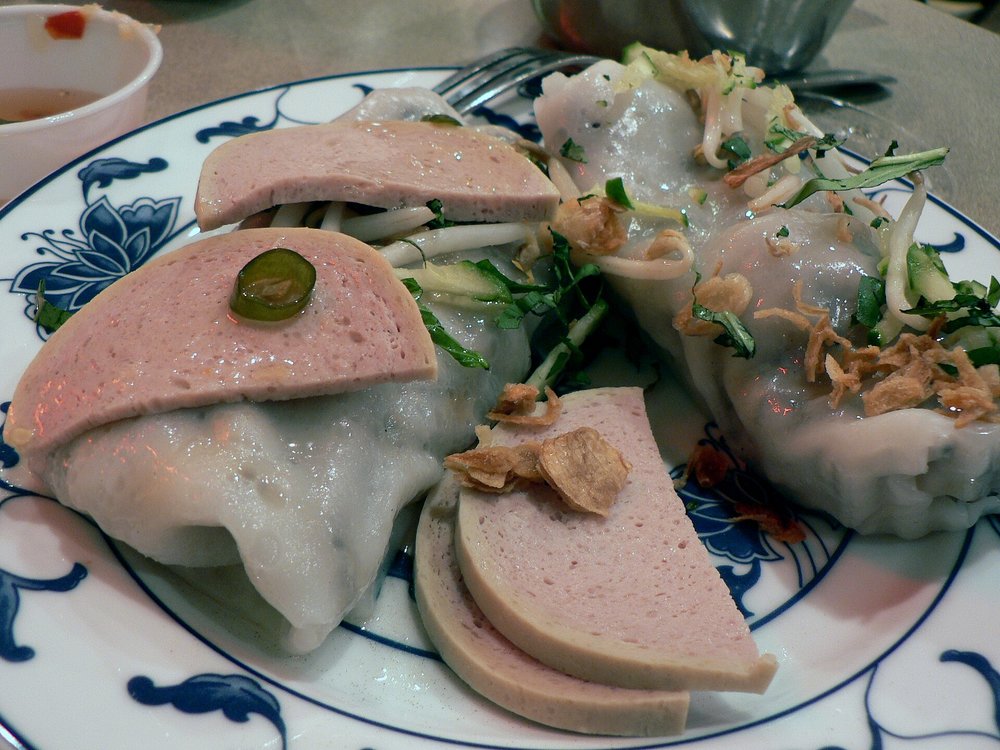 Steamed rice rolls served with Vietnamese pork sausage Gio Lua and fresh herbs