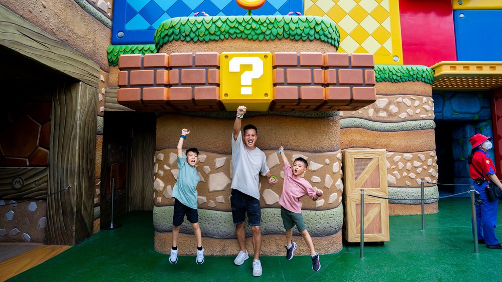 Kids and parent celebrating at Super Nintendo World in Universal Studios Japan