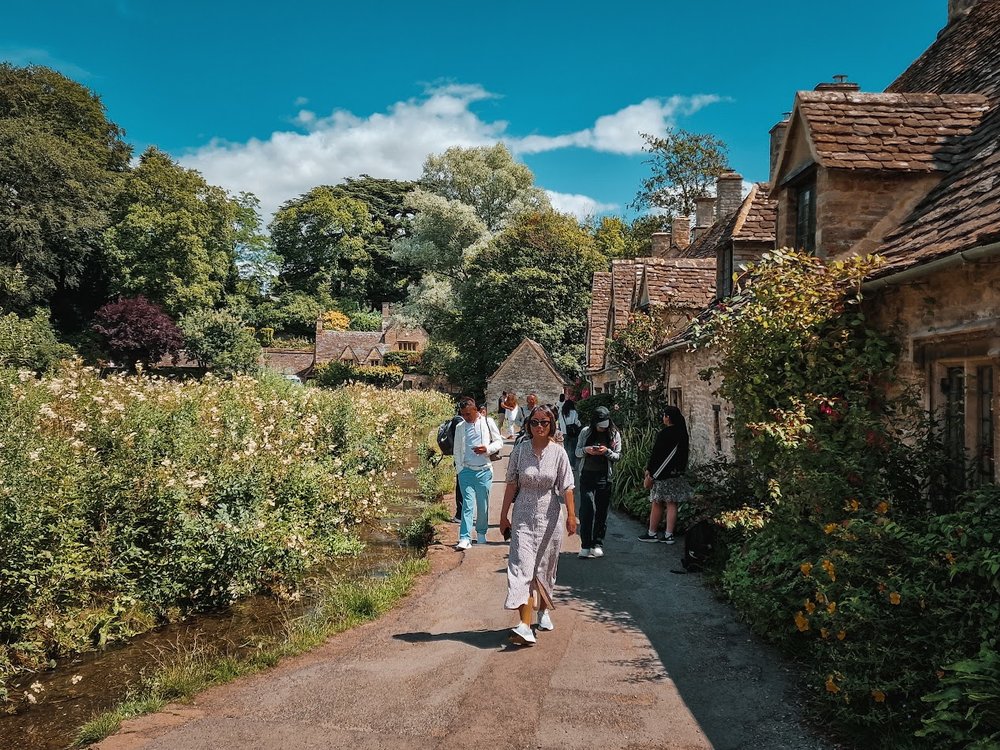 Charming village path with cottages in the Cotswolds countryside