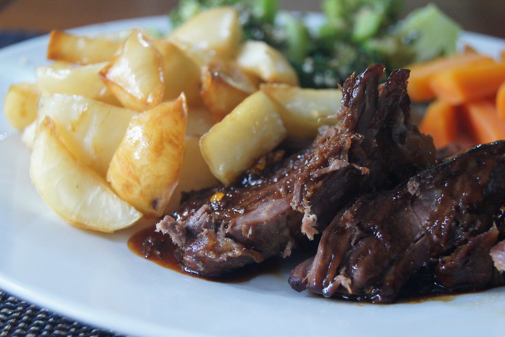 Tender honey-roasted lamb shoulder with roasted potatoes and veggies | Photo Credit: Flickr