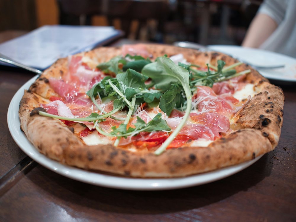 Delicious prosciutto pizza with arugula and a perfect thin crust | Photo Credit: H. Murakami on Pexels