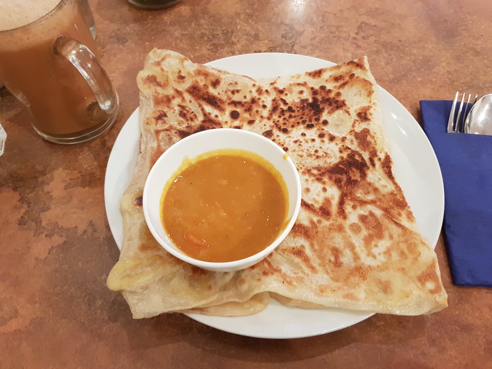 Roti canai with curry dipping sauce | Photo Credit: Wikimedia Commons