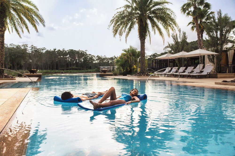 Couple relaxing by the pool at Four Seasons Resort Orlando