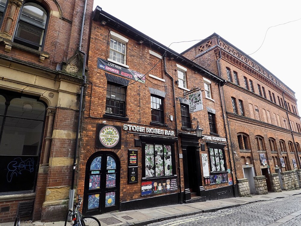 Brick building exterior of The Stone Roses Bar with signage and street view in York