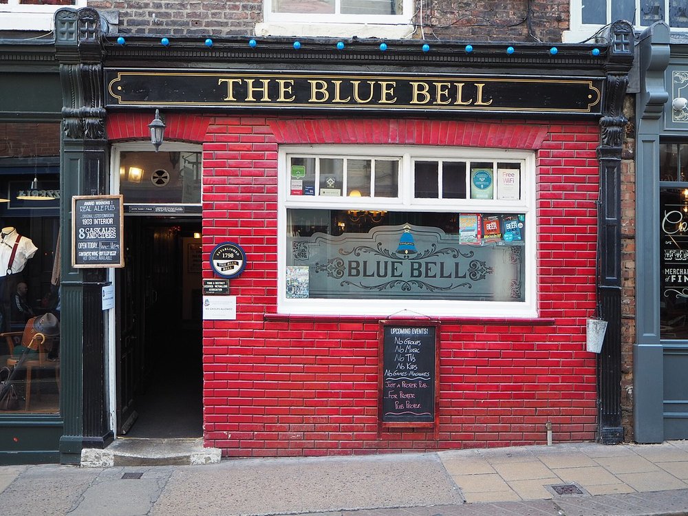 Traditional pub exterior with red brick and signage reading The Blue Bell in York