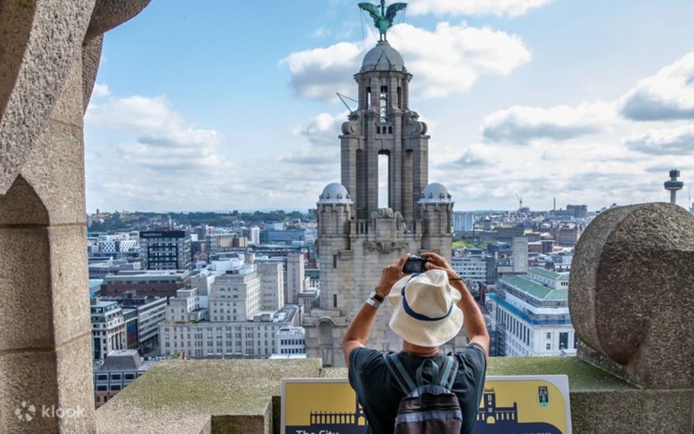 A tourist capturing the iconic Royal Liver Building
