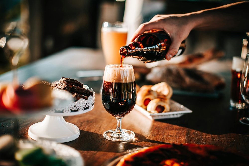 Pouring wine at a cozy bar in Nice, France | Photo Credit: Helena Lopes on Pexels
