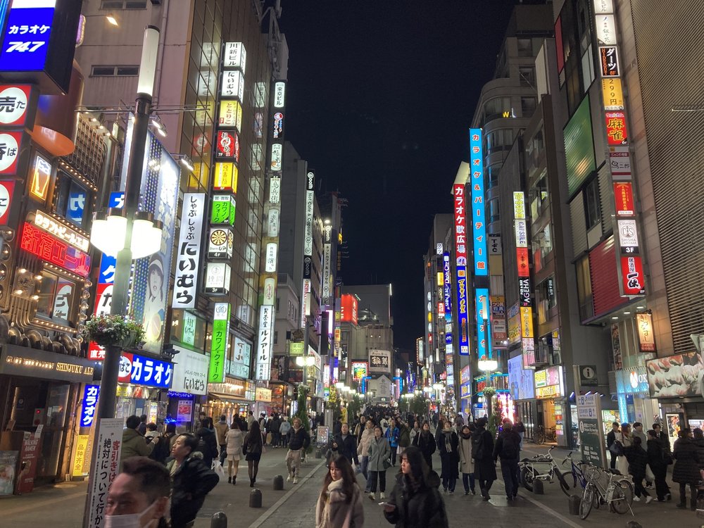 Vibrant streets of Kabukicho in Shinjuku, Tokyo, with neon signs and bustling crowds