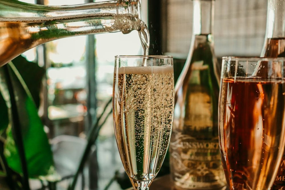 Sparkling wine being poured into a wine glass.