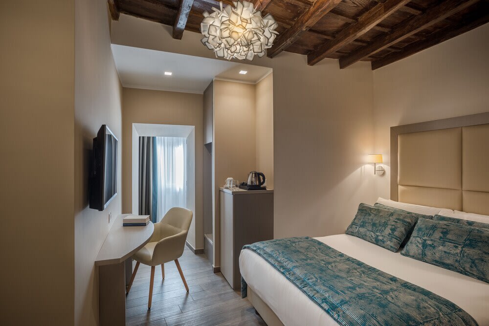Stylish bedroom interior at Reginella Suites Rome