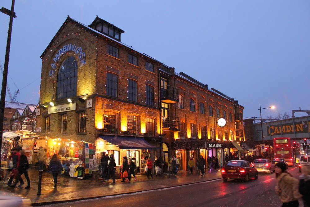 Camden Town at night with glowing lights and lively street scene | Photo from Steve Haslam on Wikimedia
