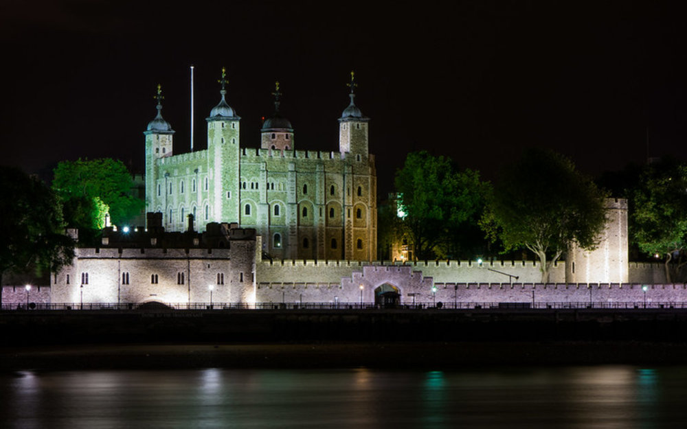Tower of London illuminated at night along the River Thames | Photo from Nan Palmero on Flickr