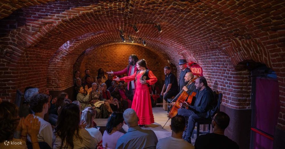 Flamenco artists performing in a brick cave