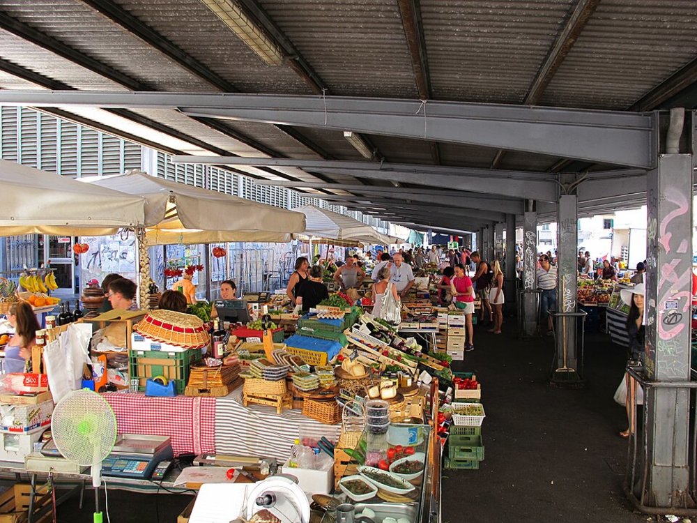 Busy Sant’Ambrogio Market with fresh produce, vendors, and locals shopping