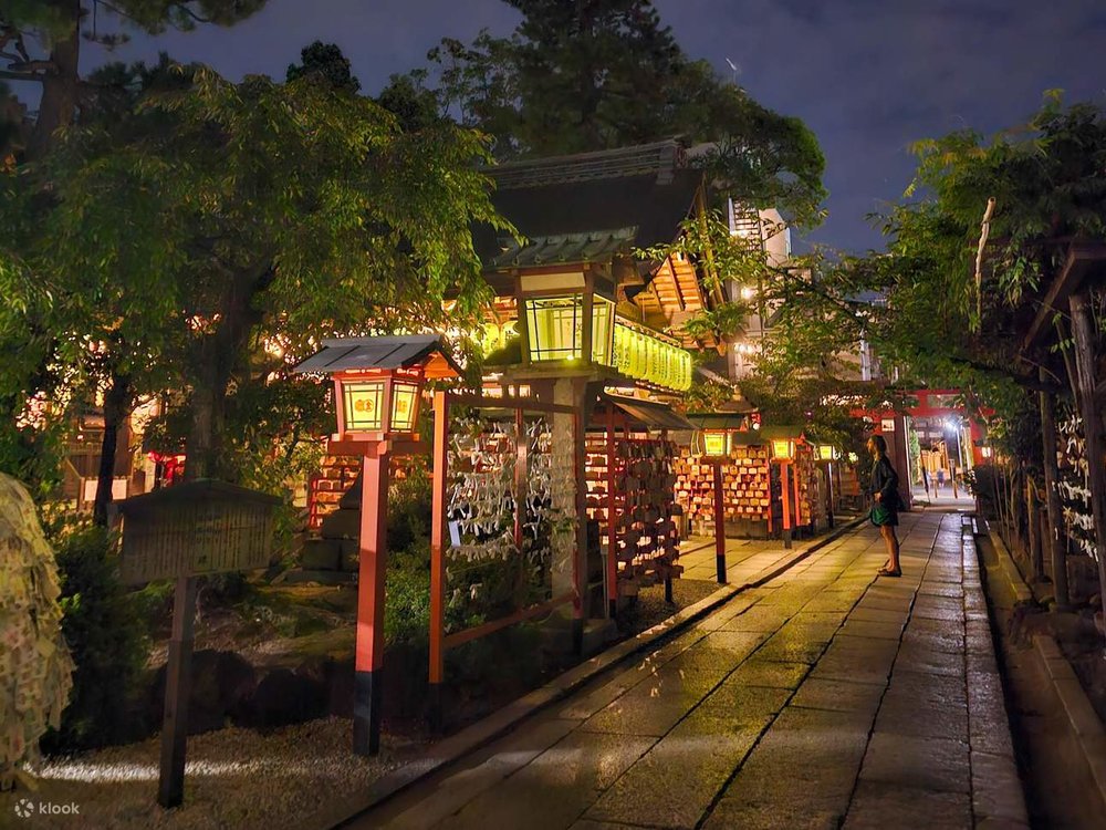 A man standing in front of what appears to be a shrine
